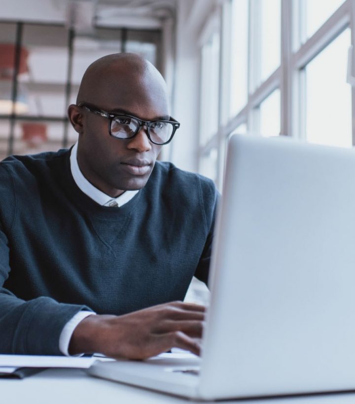 Businessman working on laptop in office